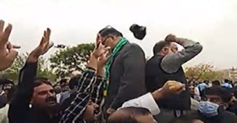 PTI workers throw a shoe on PML-N leader Ahsan Iqbal